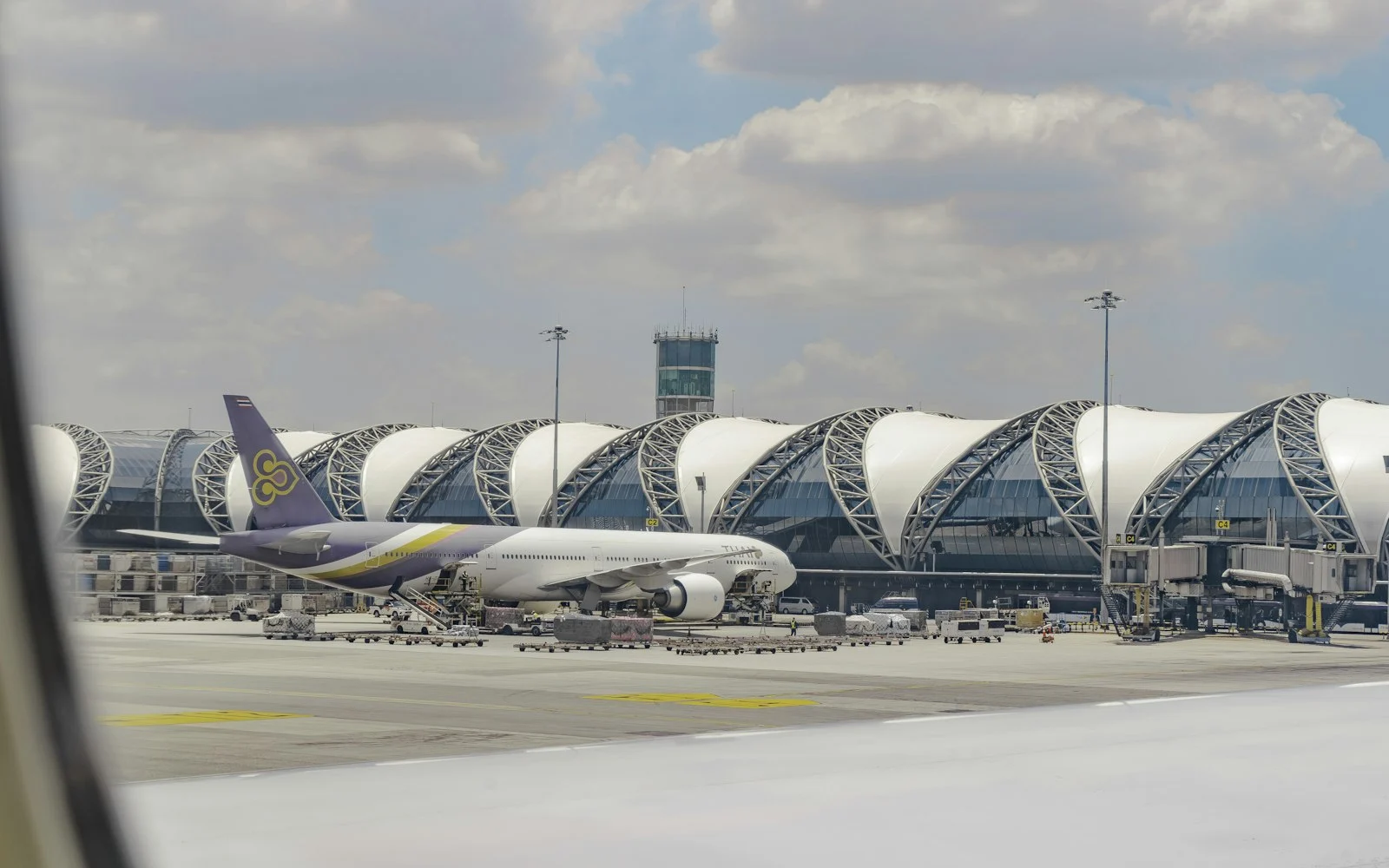 Suvarnabhumi Airport terminal exterior with distinctive curved roof, Bangkok